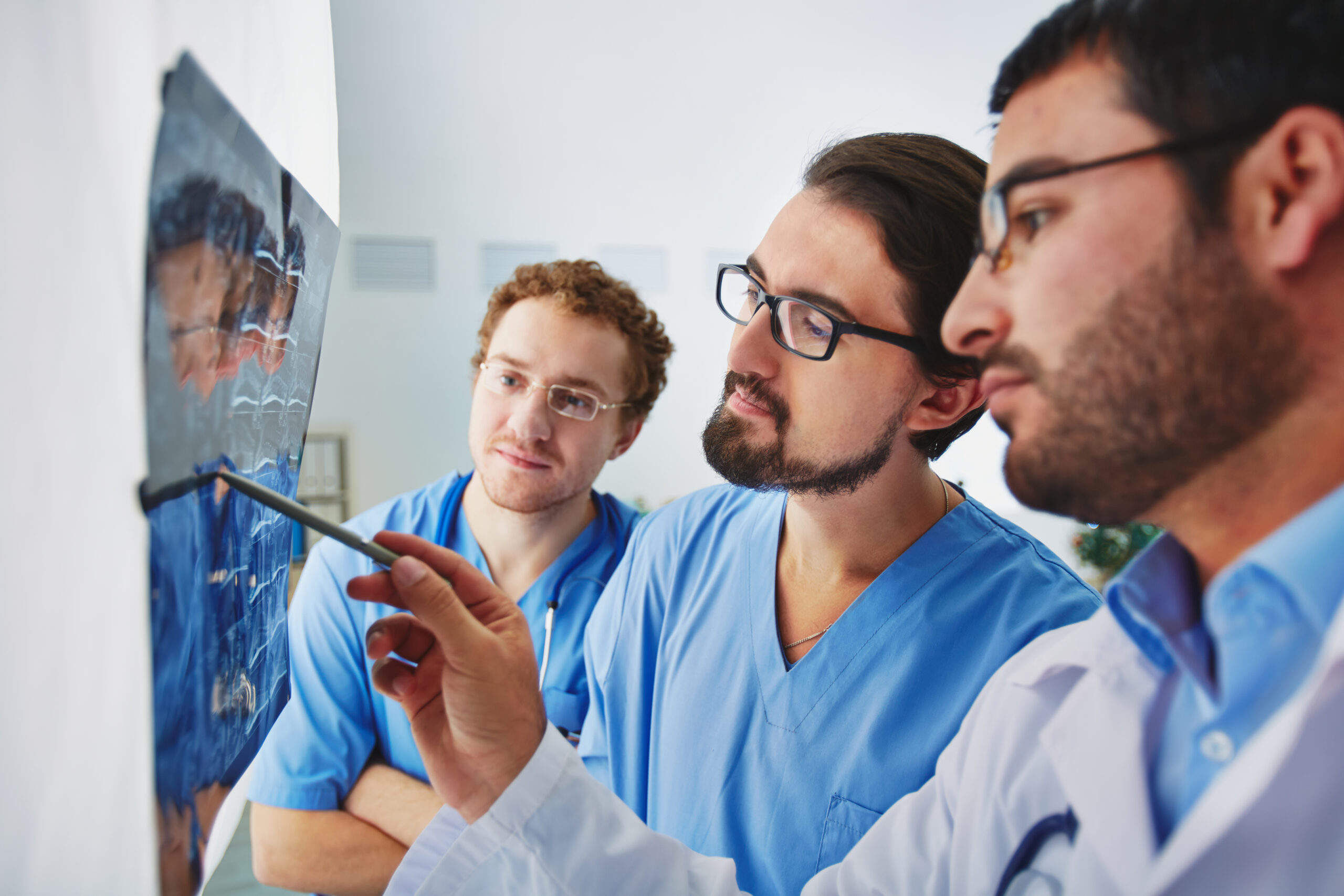 Young male doctors looking at x-ray and analyzing it